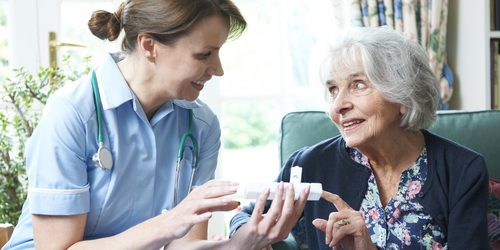 nurse helping patient at home